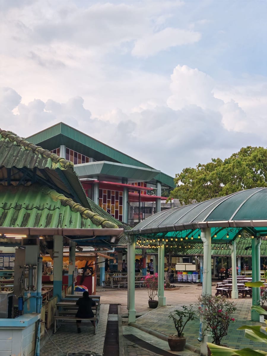 Hat Yai city skyline with temple spires and bustling street market in southern Thailand