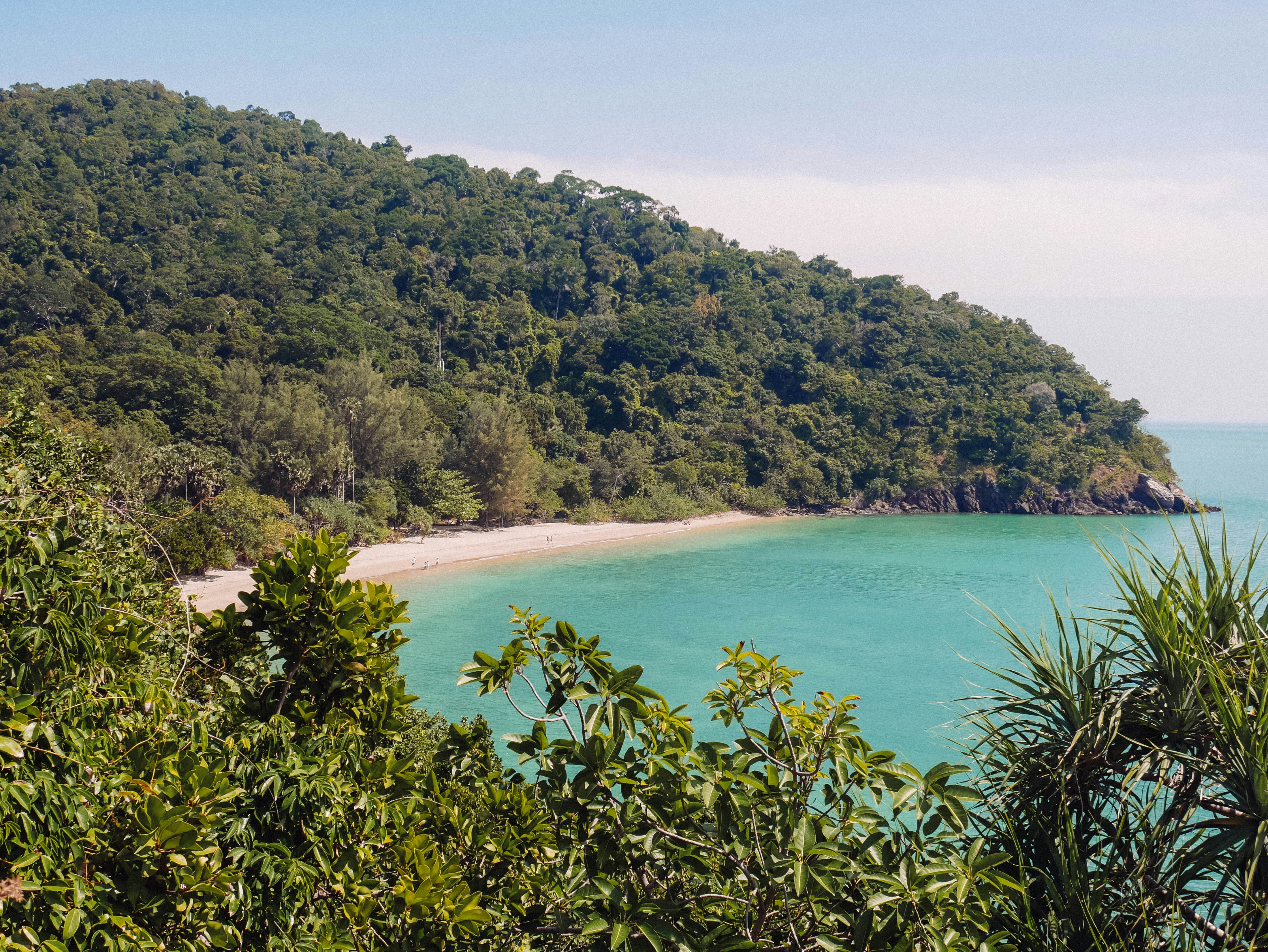 Turquoise water and forested hillside at Mu Ko Lanta National Park, Koh Lanta, Thailand