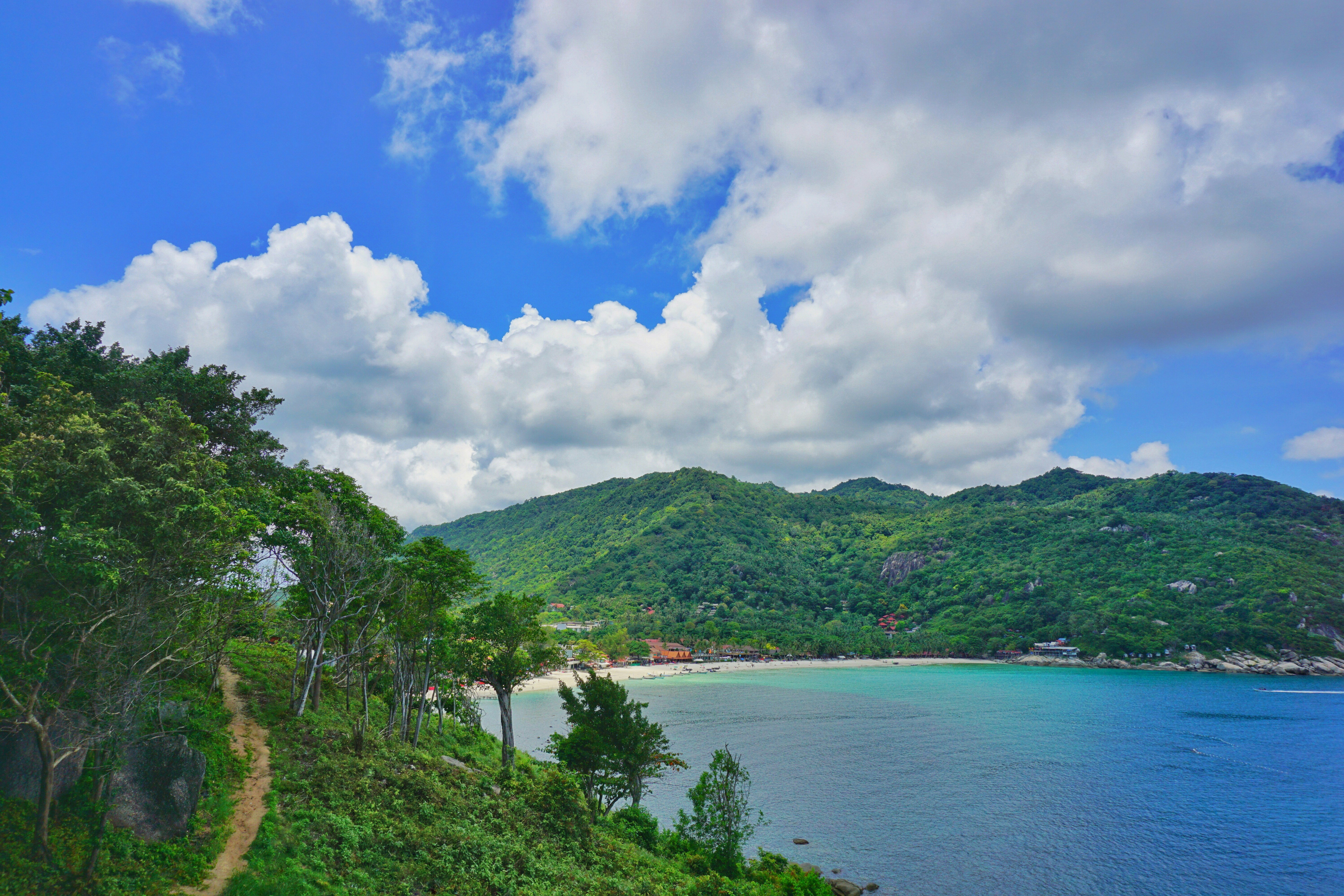 Tropical bay with clear turquoise water and forested hills, Koh Phangan, Thailand