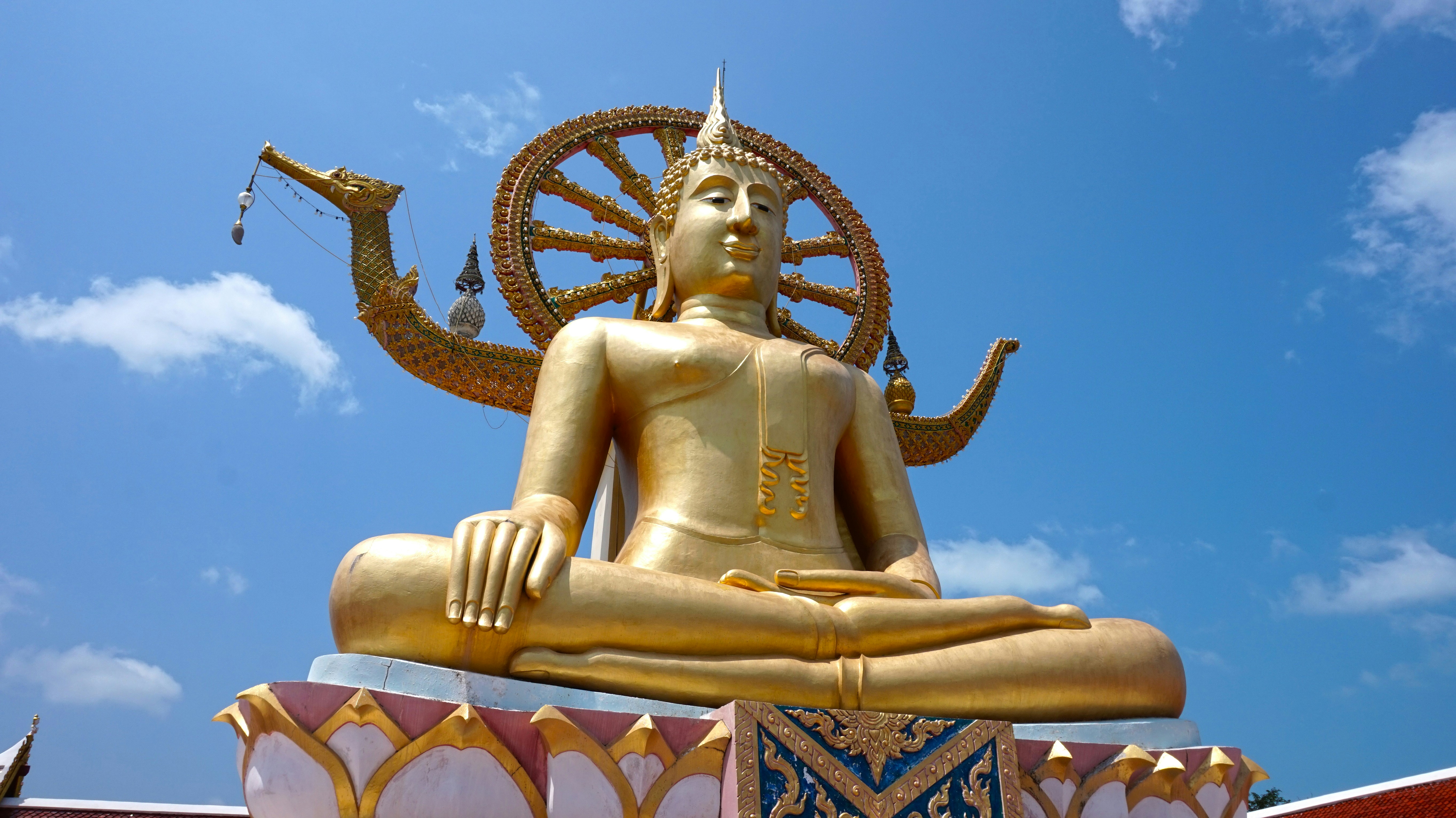 Gold Big Buddha statue at Wat Phra Yai against blue sky, Koh Samui, Thailand