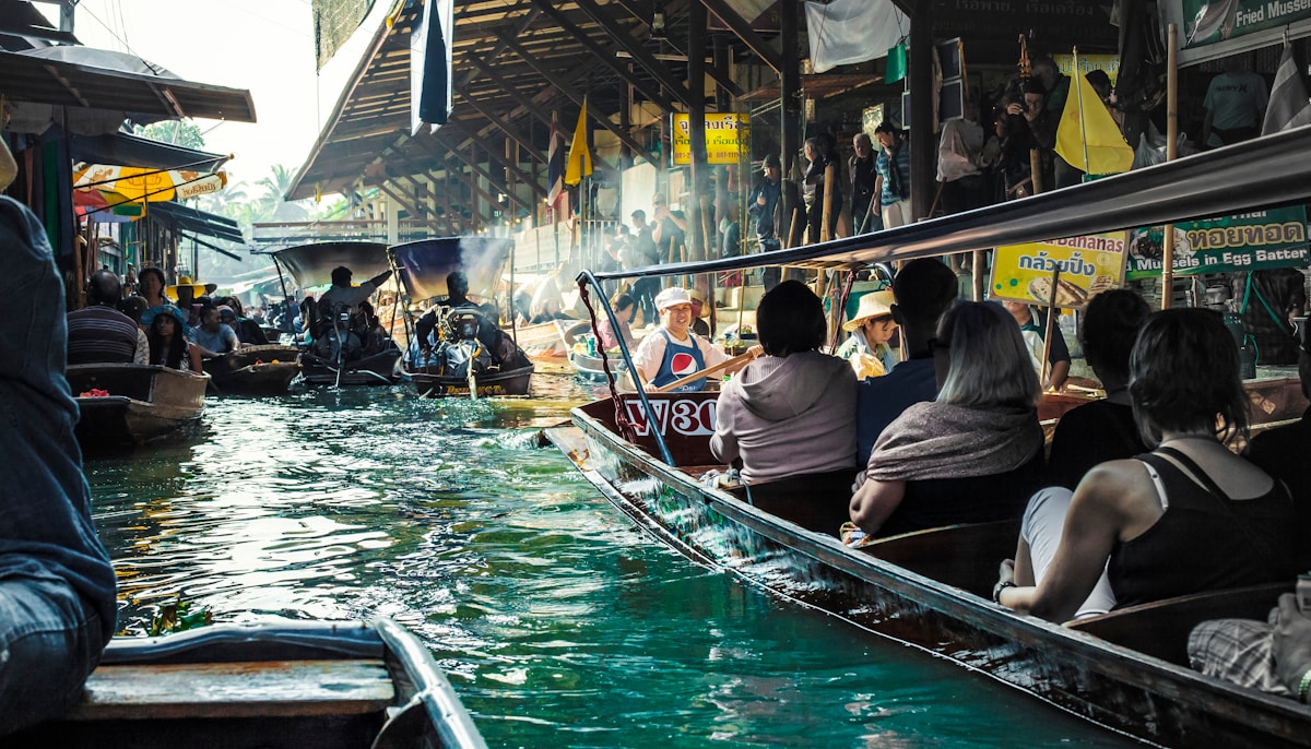 Vendor boats loaded with fruit at a Thai floating market