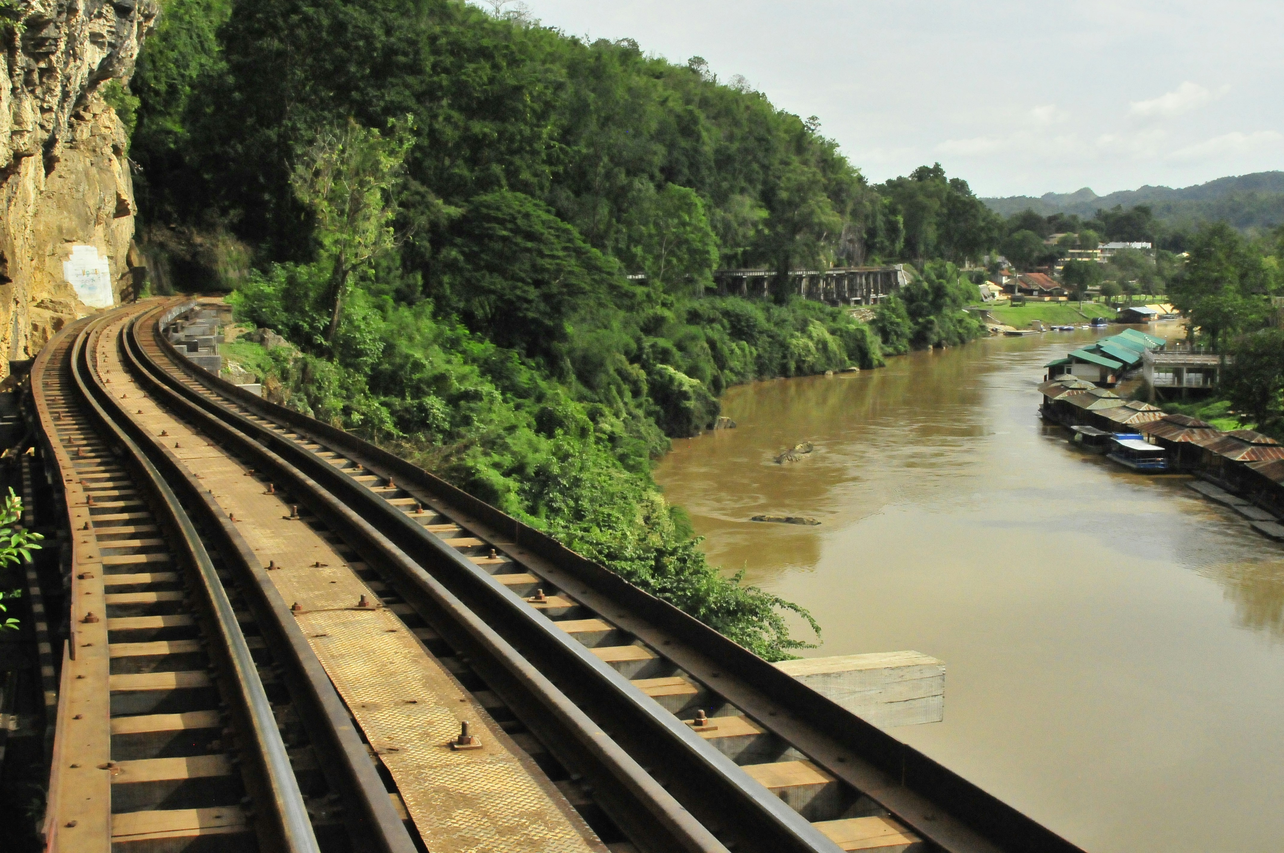 Death Railway tracks running along the Kwai Noi River through limestone cliffs, Kanchanaburi, Thailand