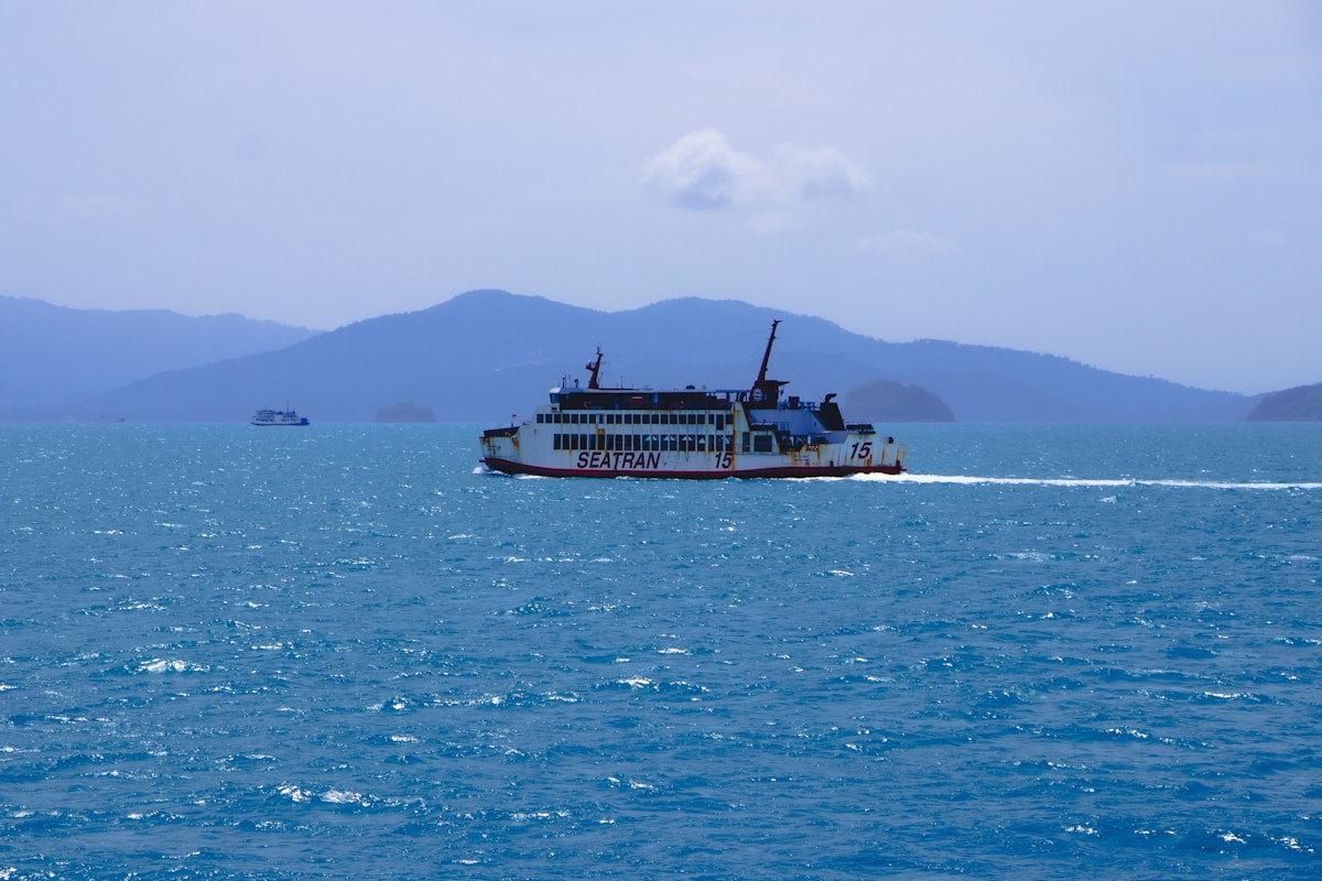 Passenger ferry crossing calm Gulf of Thailand between Koh Samui and Koh Phangan at golden hour