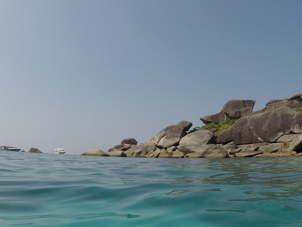 Crystal-clear turquoise water beside granite boulders at the Similan Islands, Thailand