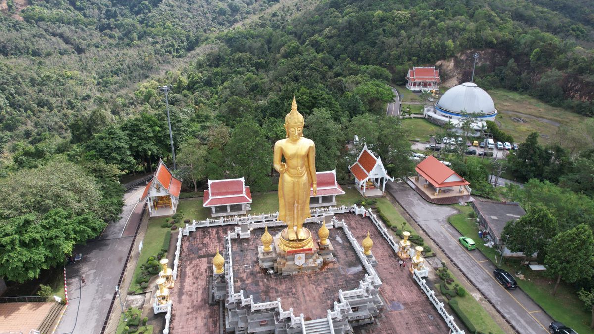 Aerial view of the golden standing Buddha at Kho Hong Hill, Hat Yai