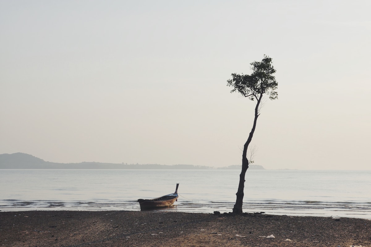 Long stretch of golden sand beach on Koh Lanta with calm Andaman Sea water