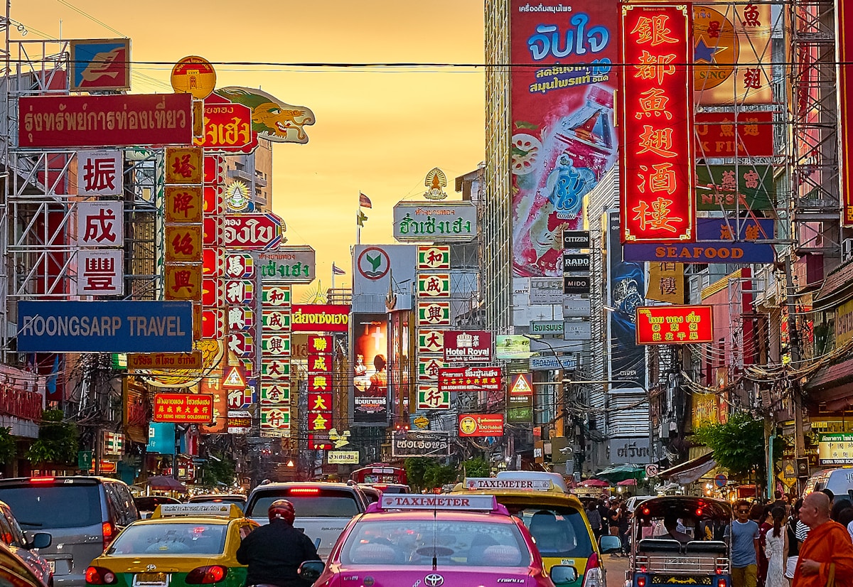 Busy street with vehicles and Kanji script signage, Chinatown, Bangkok, Thailand