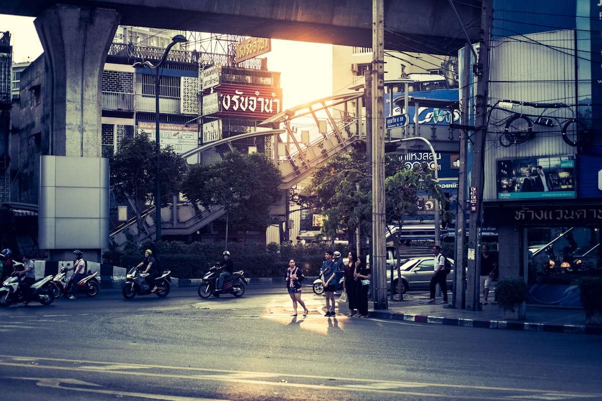 People walking on a pedestrian lane past shophouses and buildings, Bangkok, Thailand
