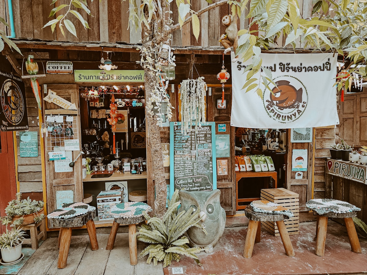 Quirky wooden cafe with stools and Thai signage on the street in Chiang Mai