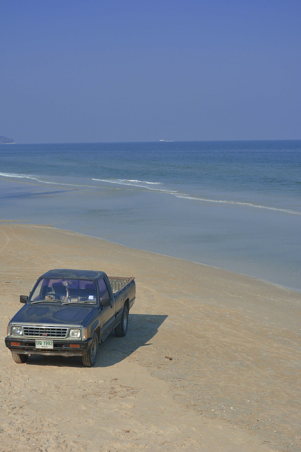 Hua Hin beach with traditional Thai fishing boats and sand dunes
