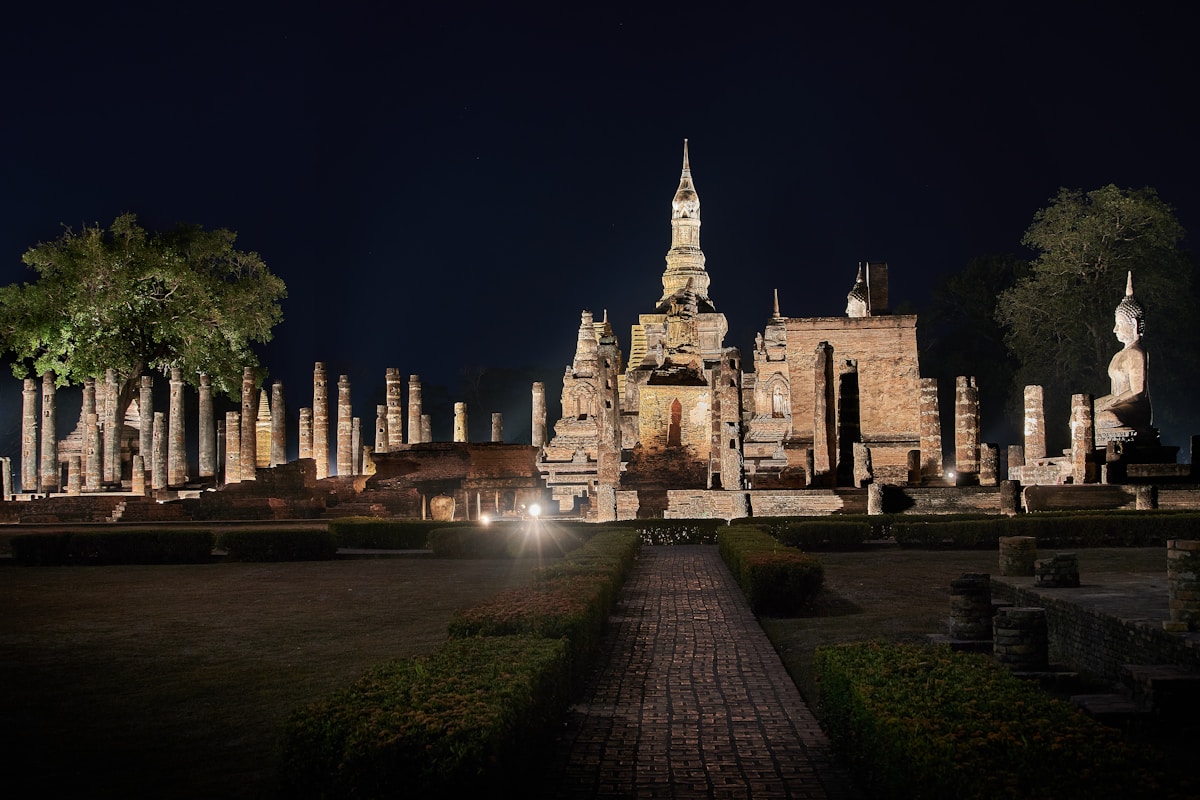 Macaque monkeys climbing ancient Khmer-style temple ruins in Lopburi, Thailand