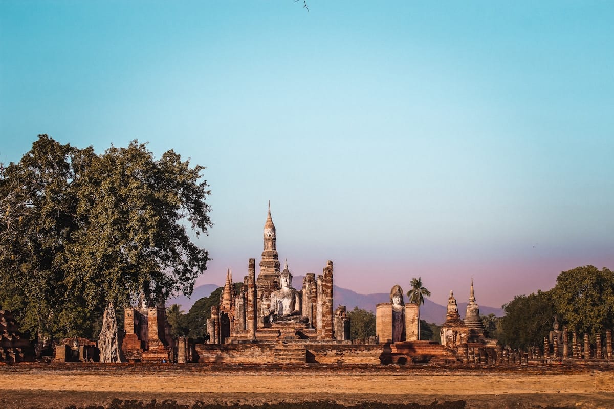 Seated Buddha statue at Wat Si Chum surrounded by lotus pond, Sukhothai