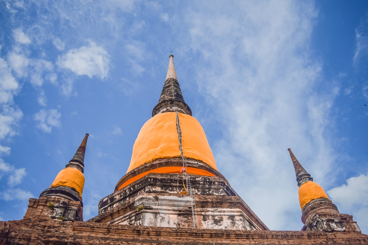 Brown and black temple building under blue sky, Ayutthaya, Thailand