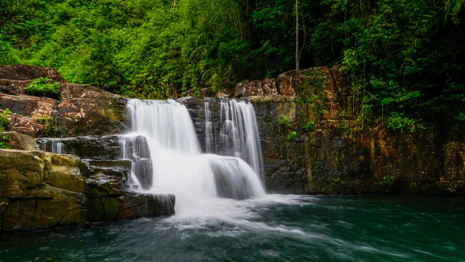 Multi-tiered waterfall cascading into turquoise pool in tropical forest, Khlong Yai Kee, Ko Kut, Trat, Thailand