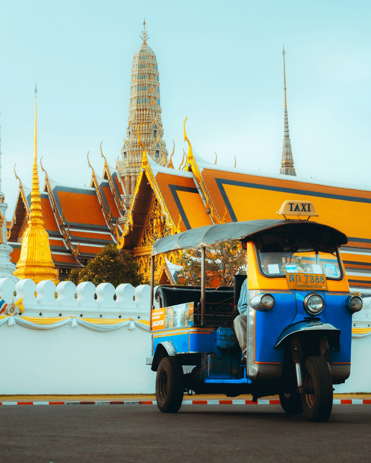 Blue and yellow tuk-tuk outside the Grand Palace, Bangkok