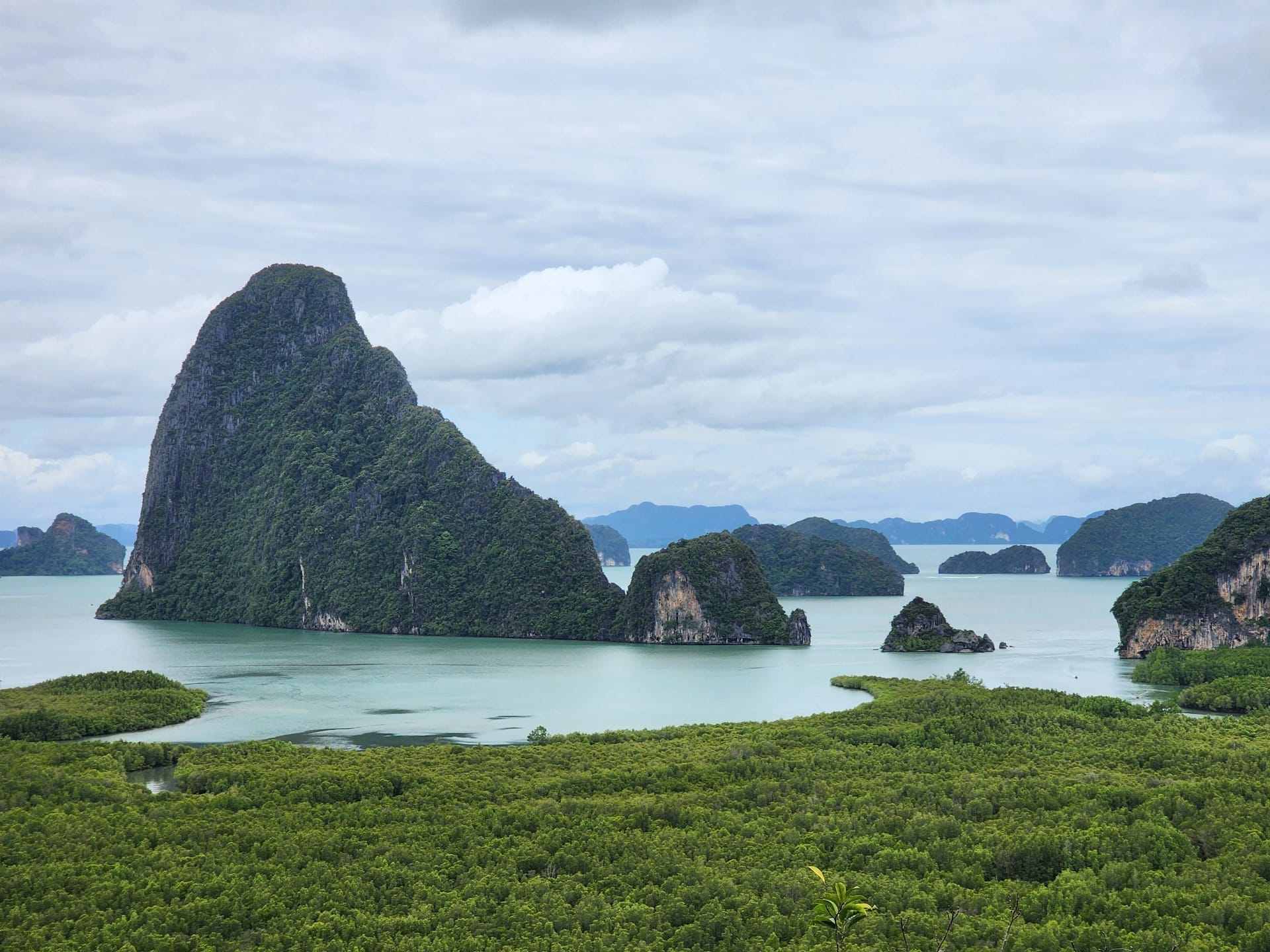 Phang Nga Bay limestone formations rising from emerald-green water, Thailand
