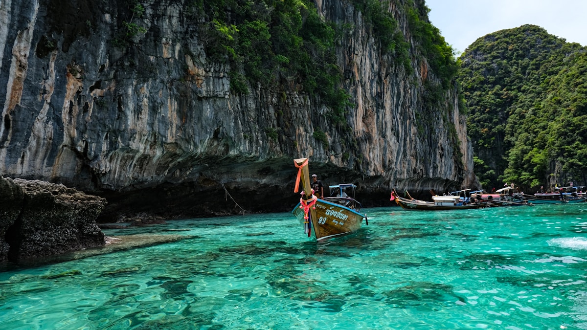 Group of longtail boats floating on calm turquoise water at Phi Phi Islands, Krabi, Thailand