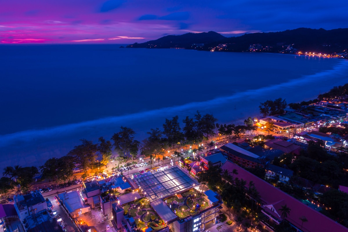 Aerial view of Patong Beach at twilight with city lights, Phuket, Thailand