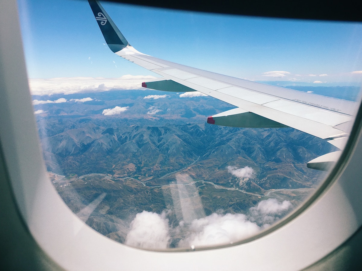 Airplane wing seen through a cabin window in flight