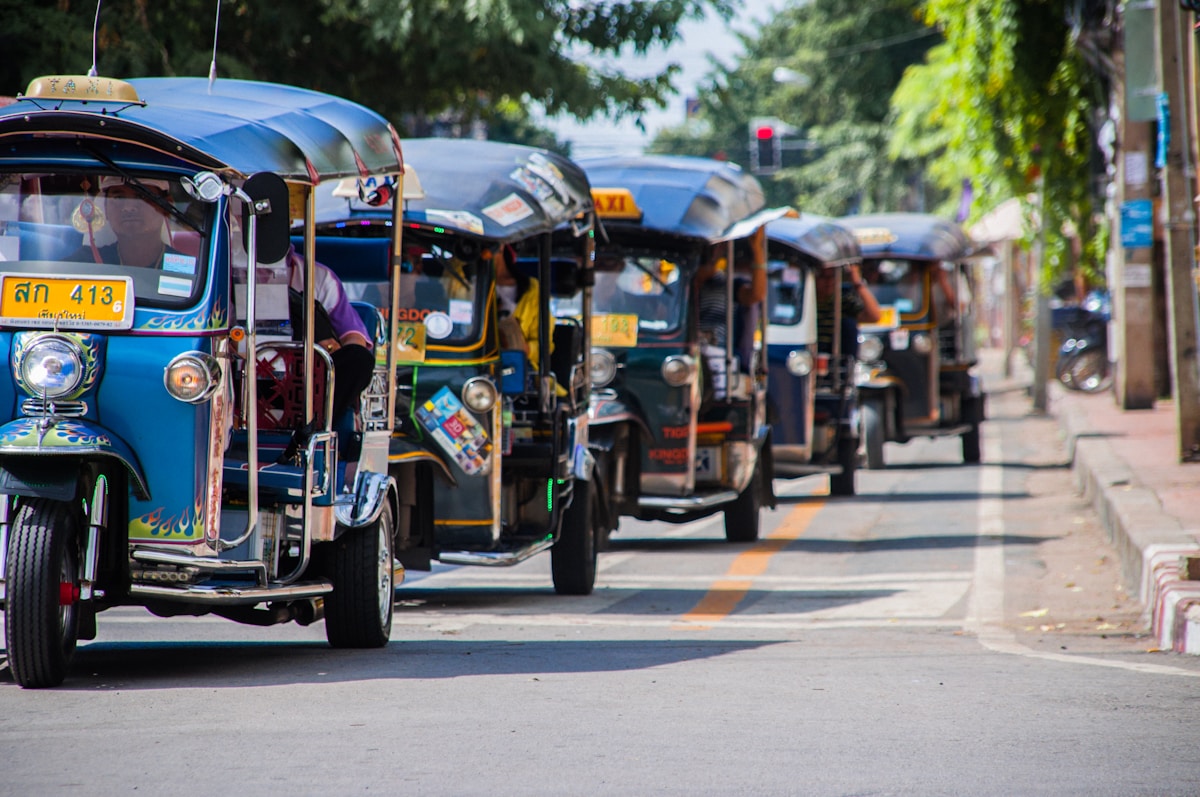 Blue-and-yellow tuk-tuk parked on a street, Chiang Mai, Thailand