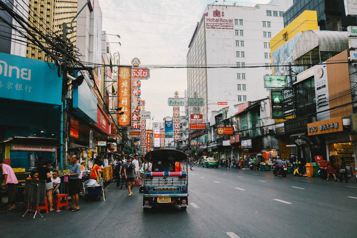Bangkok Chinatown street scene with a tuk-tuk and colourful shop signs