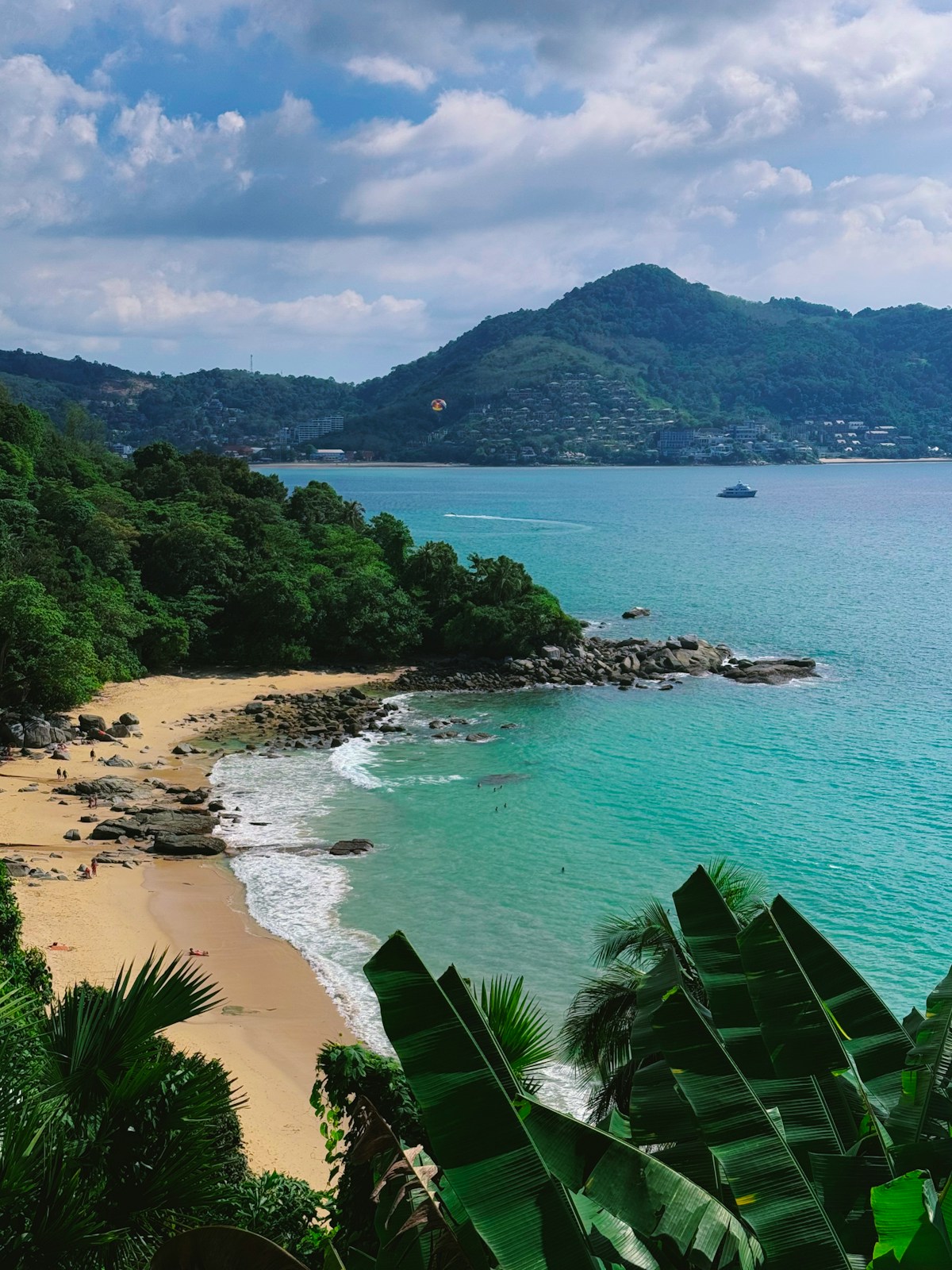 Turquoise bay with sandy beach and green hills, Kamala, Phuket, Thailand