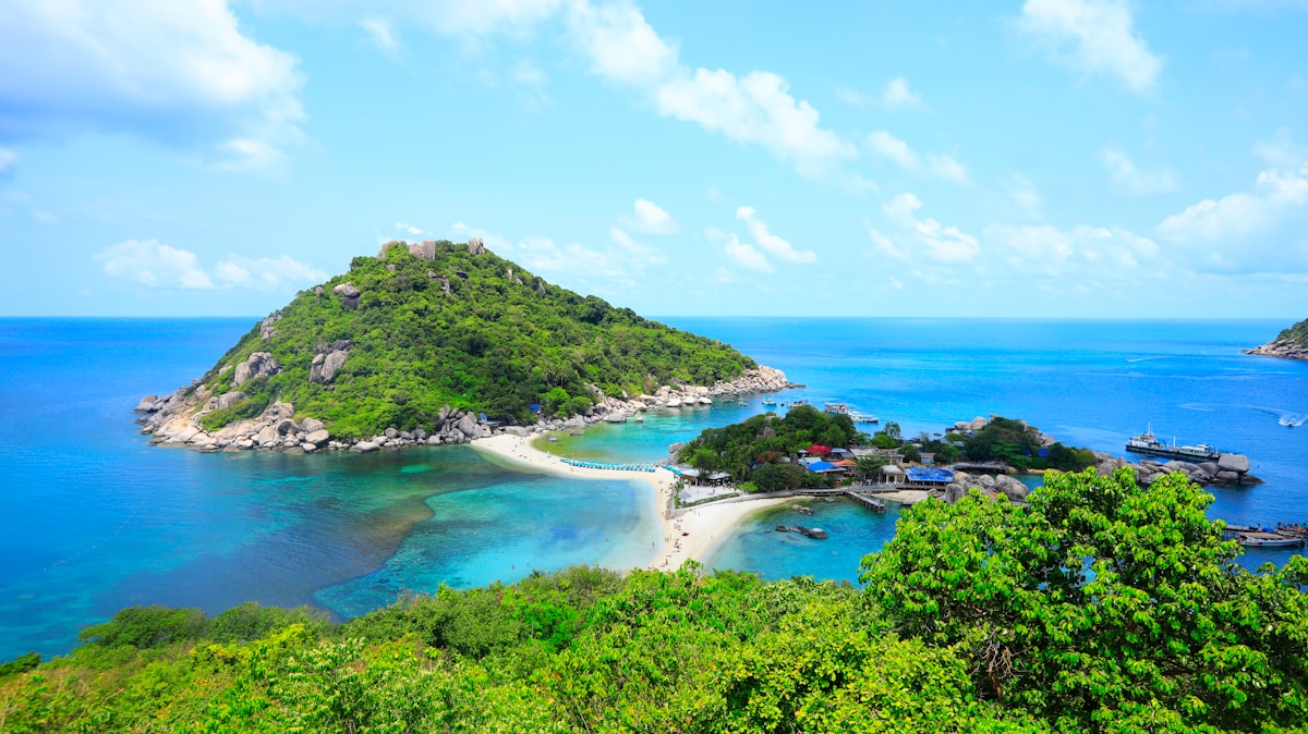 Aerial view of a lush green tropical island surrounded by turquoise sea, Koh Samui, Thailand