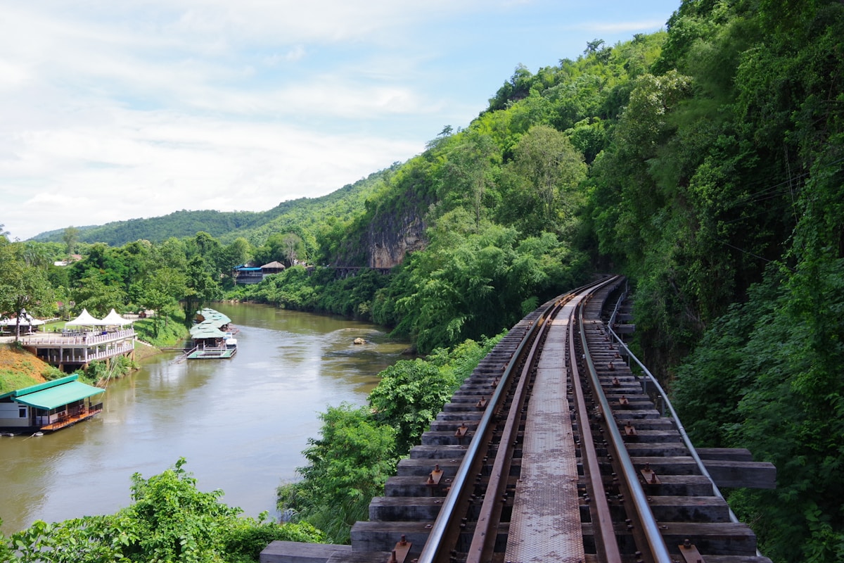 Death Railway viaduct over lush river valley, Kanchanaburi — July