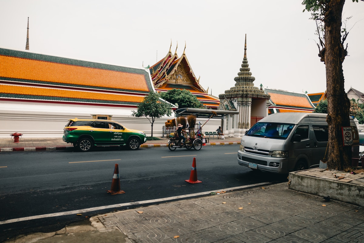 Bangkok taxi passing the ornate walls of a Thai temple near Wat Pho