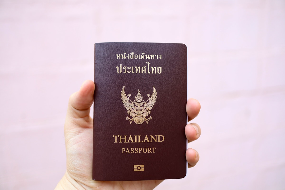 Hand holding a Thailand passport - visa and entry requirements