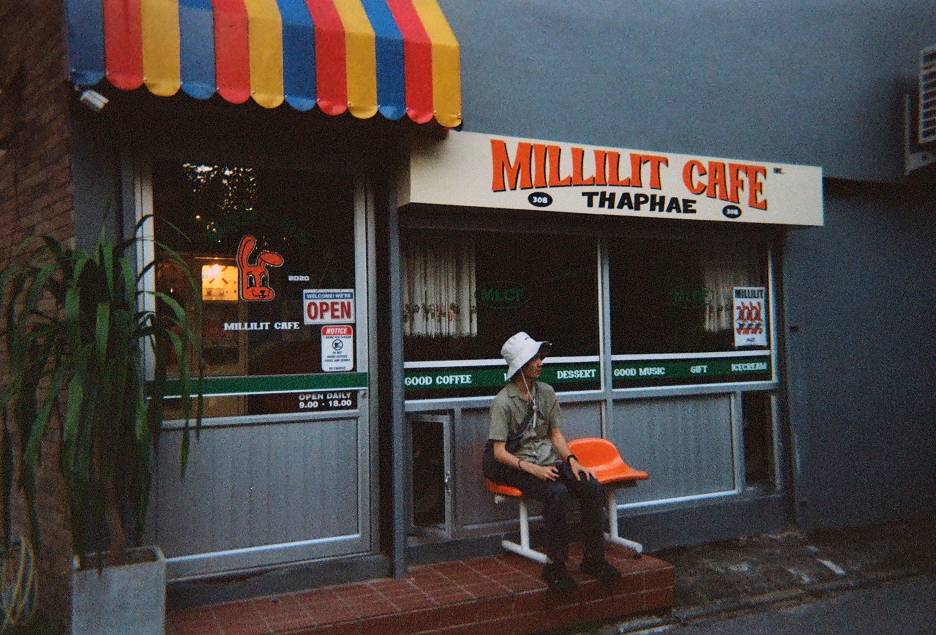 Man sitting outside Millilit Cafe on Thaphae Road, Chiang Mai