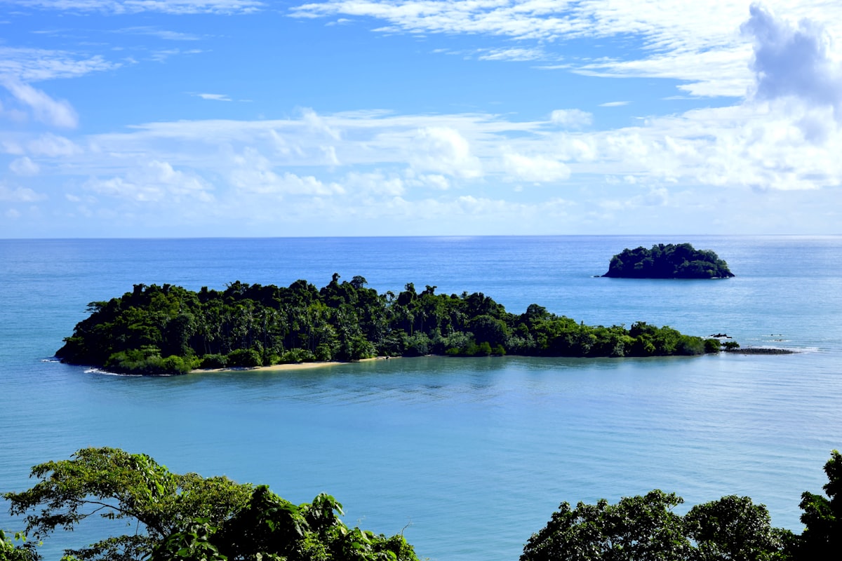 Small jungle-covered islands in clear blue water viewed from Koh Chang, Trat Province, Thailand