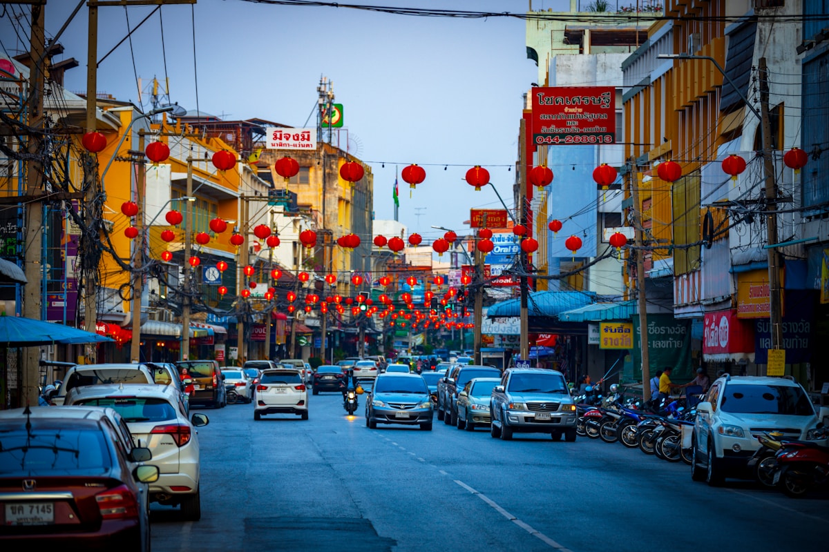City street with red lanterns and commercial buildings at dusk, Nakhon Ratchasima, Thailand